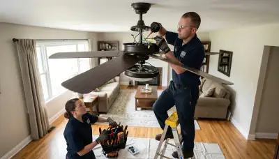 Electrician repairing a ceiling fan in a Sarasota, FL home