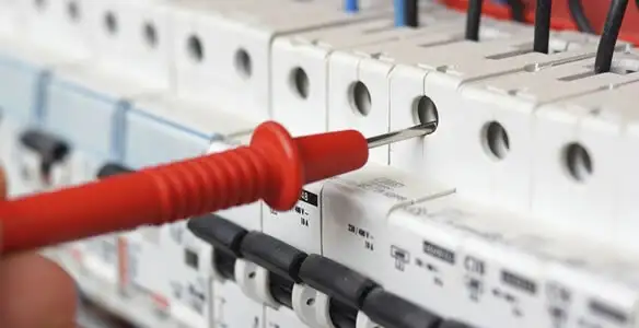 Electrical contractor testing circuit breakers during electrical repair in Osprey, FL