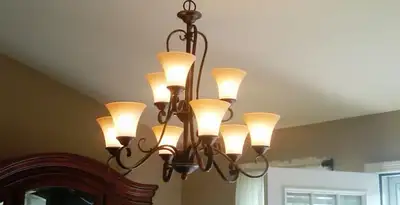 Classic ceiling chandelier installation with warm lighting in Sarasota, FL