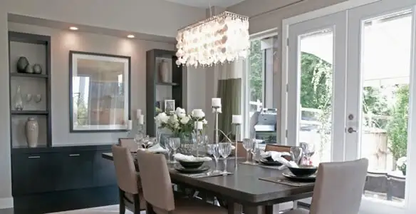 Elegant dining room chandelier installation above table in Sarasota, FL