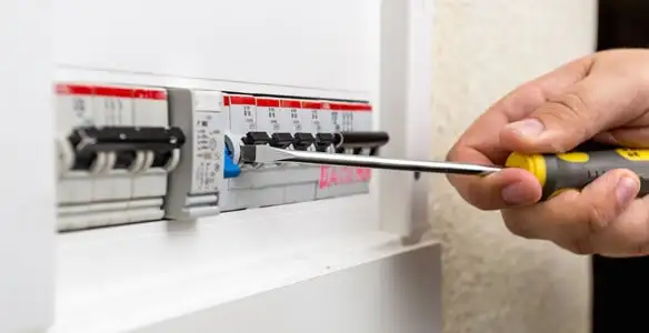 electrical panel upgrade service showing technician adjusting circuit breakers during system upgrade in Sarasota, FL