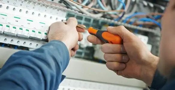 electrical service showing licensed electrician performing electrical panel maintenance and adjustments in Sarasota, FL