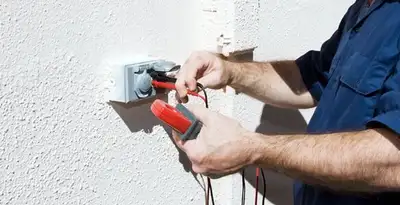 Electrician performing home electrical outlet and wiring inspection in Sarasota, FL