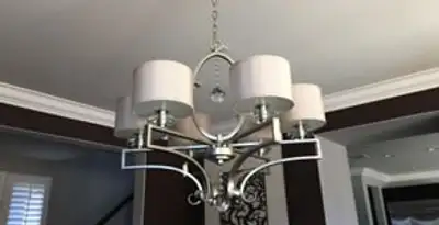 Modern chandelier installation with multiple light fixtures in Sarasota, FL