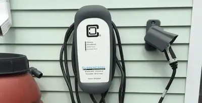 Outdoor electric vehicle charger installation on residential wall in Sarasota, FL