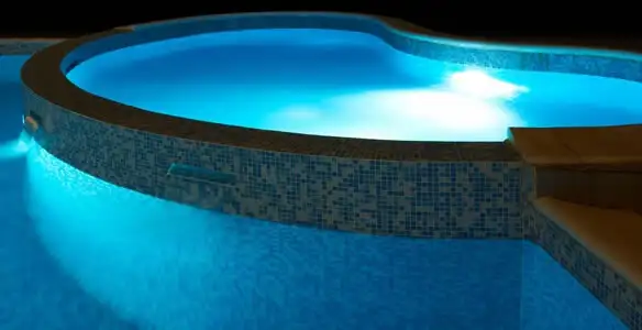 pool light installation and repair services highlighting illuminated pool interior lighting in Sarasota, FL