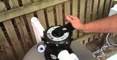 pool pumps service showing professional adjustment of pool pump control system in Sarasota, FL
