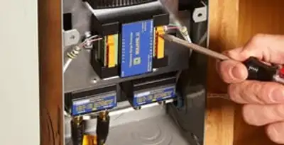 Whole home surge protection device being installed by a licensed electrician to protect electrical systems in Sarasota, FL